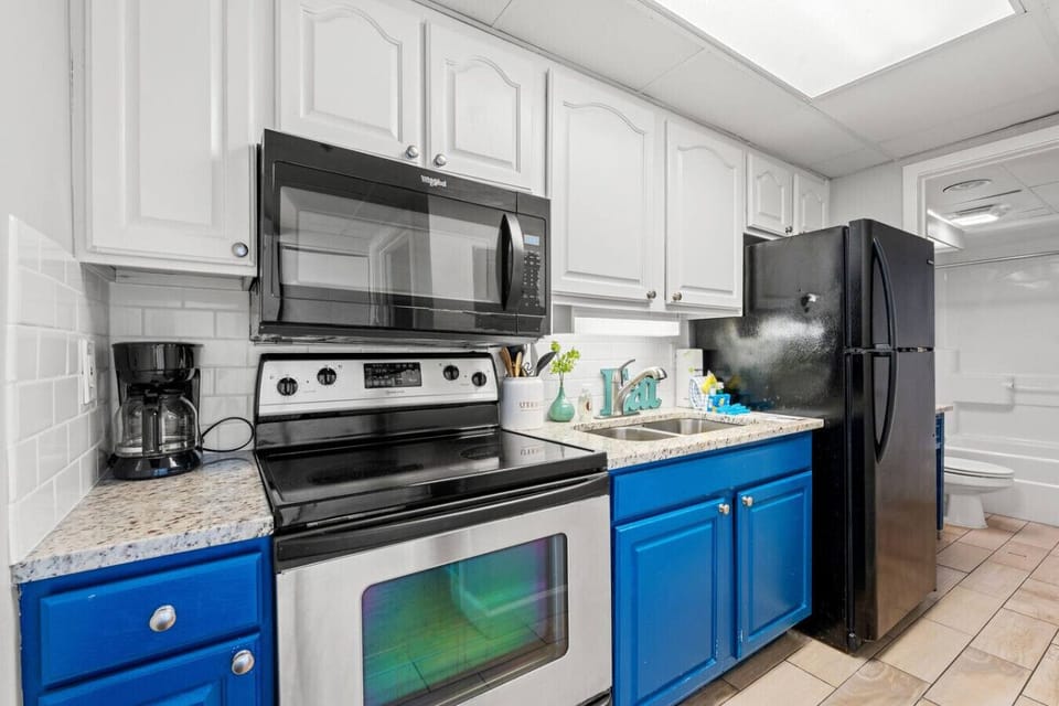 Fully equipped kitchen with modern appliances, cookware, and dinnerware. Easily prepare family meals on vacation and enjoy the comfort of home in Myrtle Beach.