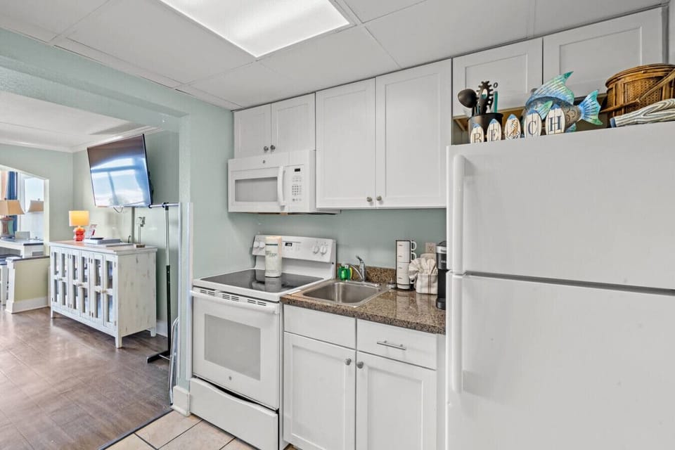 Full Oven Stove with 4-burner stovetop, Sink, Full-Sized Refrigerator, Microwave, and a Keurig Coffee Maker
