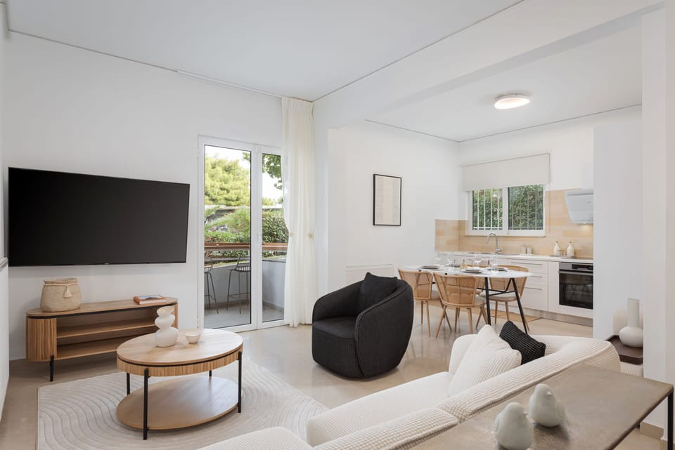 Deluxe Apartment, Balcony, Sea View | Living area | 55-inch Smart TV with satellite channels