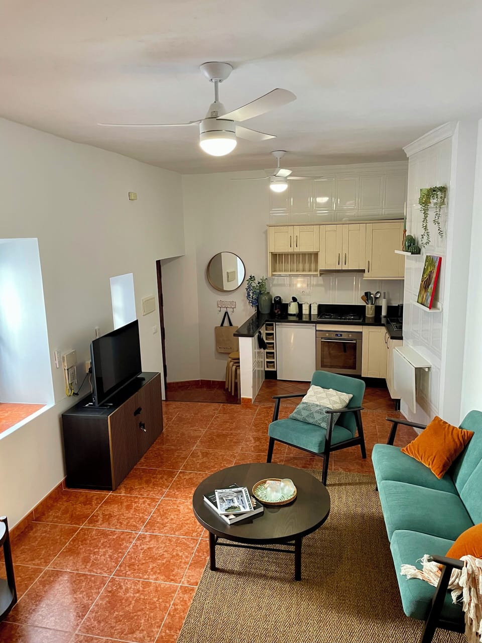 The view of the living room and open-plan kitchen from the second floor. 
