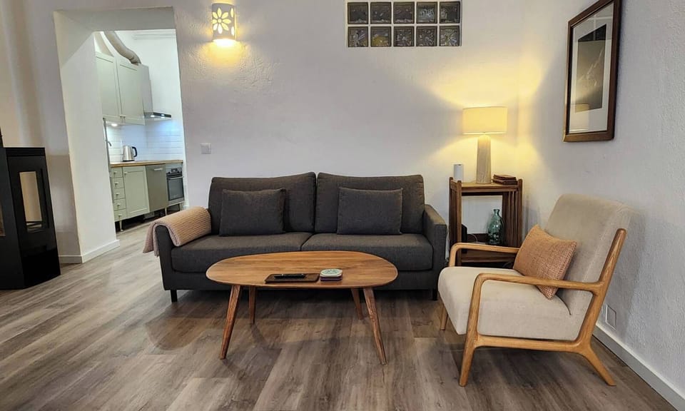 Living room seating area contains; sofa, chairs and coffee tables. 