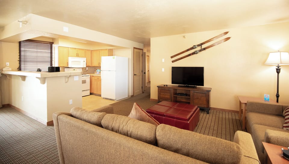 Two Bedroom | Living area | 49-inch LCD TV with cable channels, DVD player