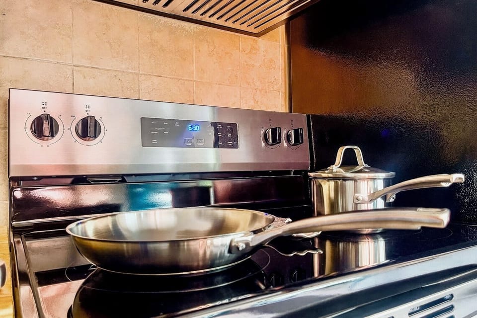 Sleek stainless steel cookware and modern range make cooking meals easy.