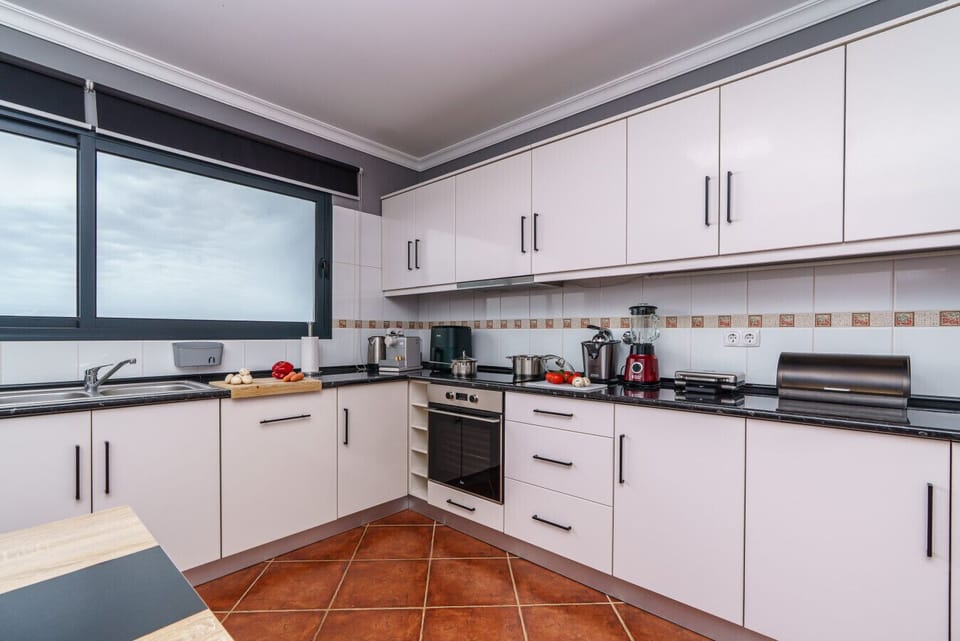 Cook like home with premium appliances and smart design in this modern kitchen setup.