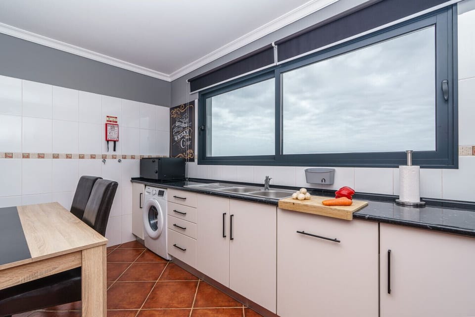 Well-equipped with modern conveniences and a coastal view, this kitchen makes island living effortless.