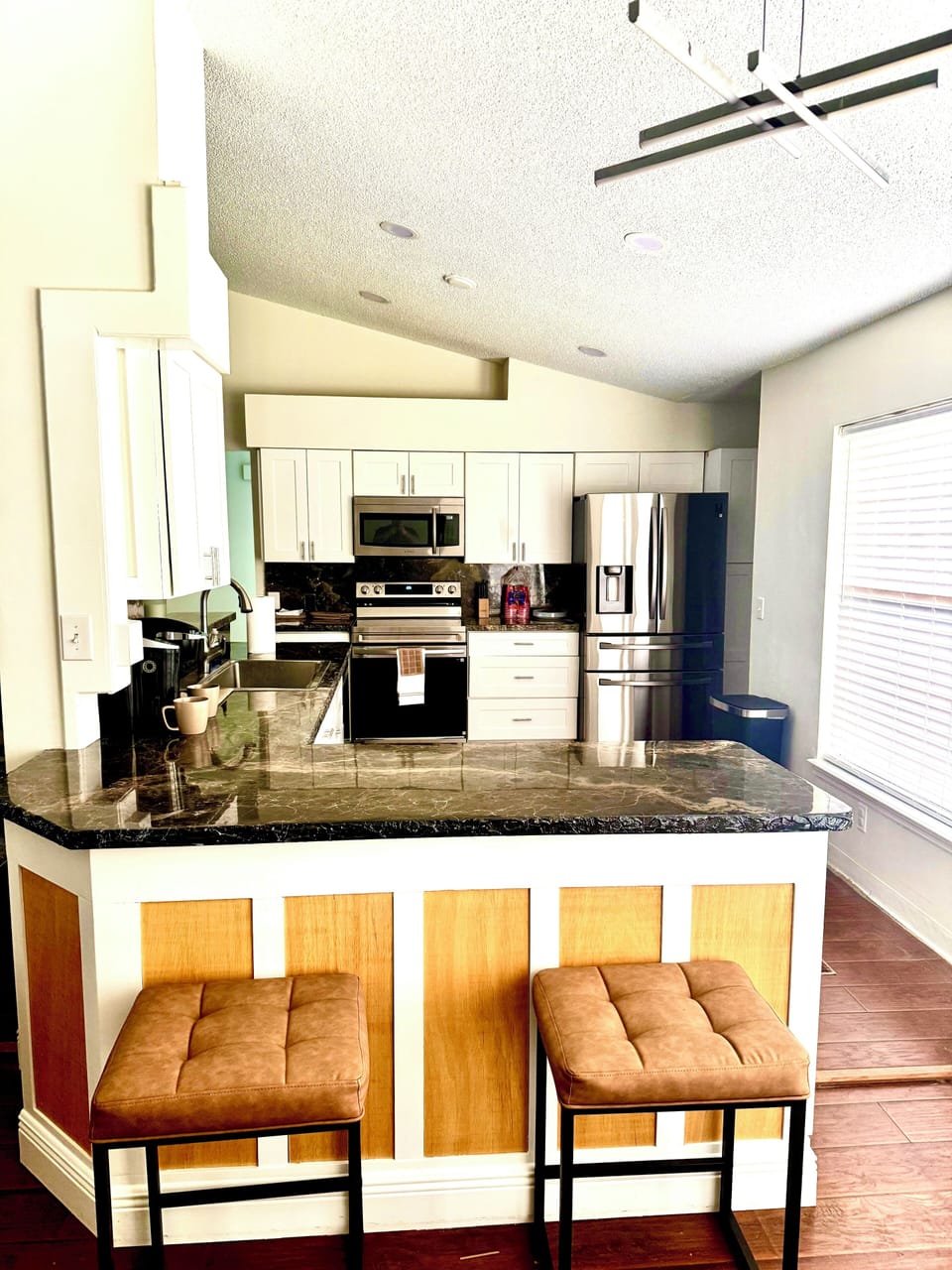 Kitchen area with bar stools