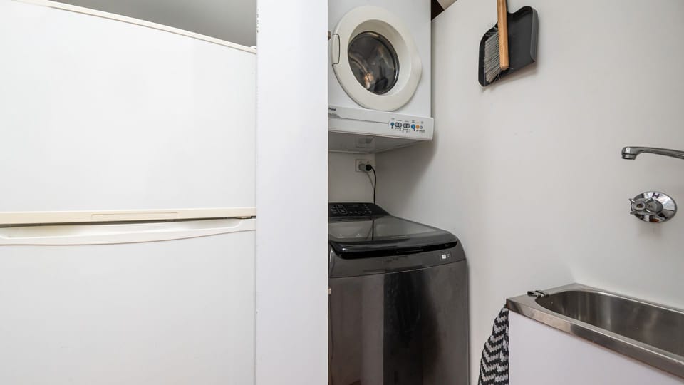 Laundry located to the right of the fridge in kitchen  with washing machine and dryer 