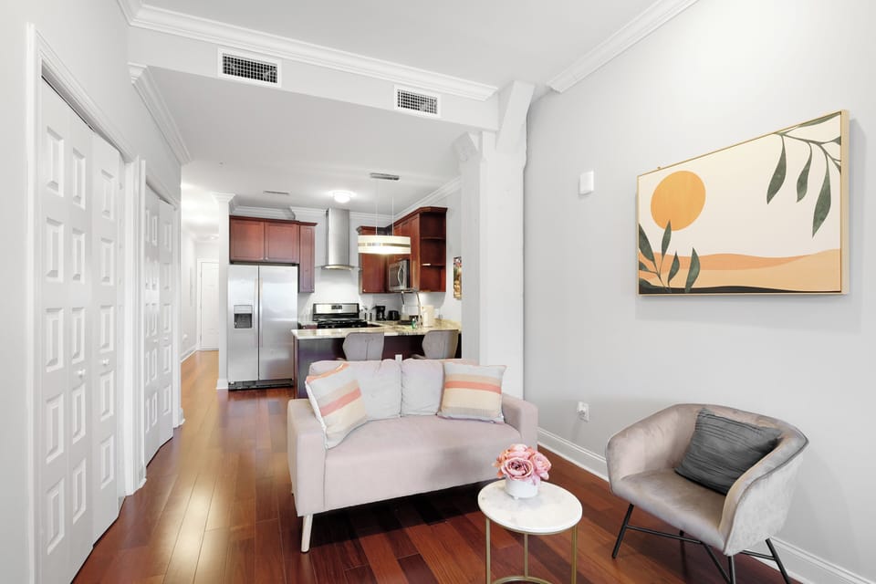 Living area with comfortable sofa, flat-screen smart TV, and open layout.
