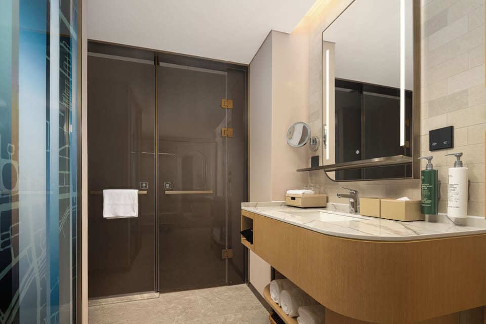 Comfort Room, 1 King Bed | Bathroom | Designer toiletries, hair dryer, slippers, towels