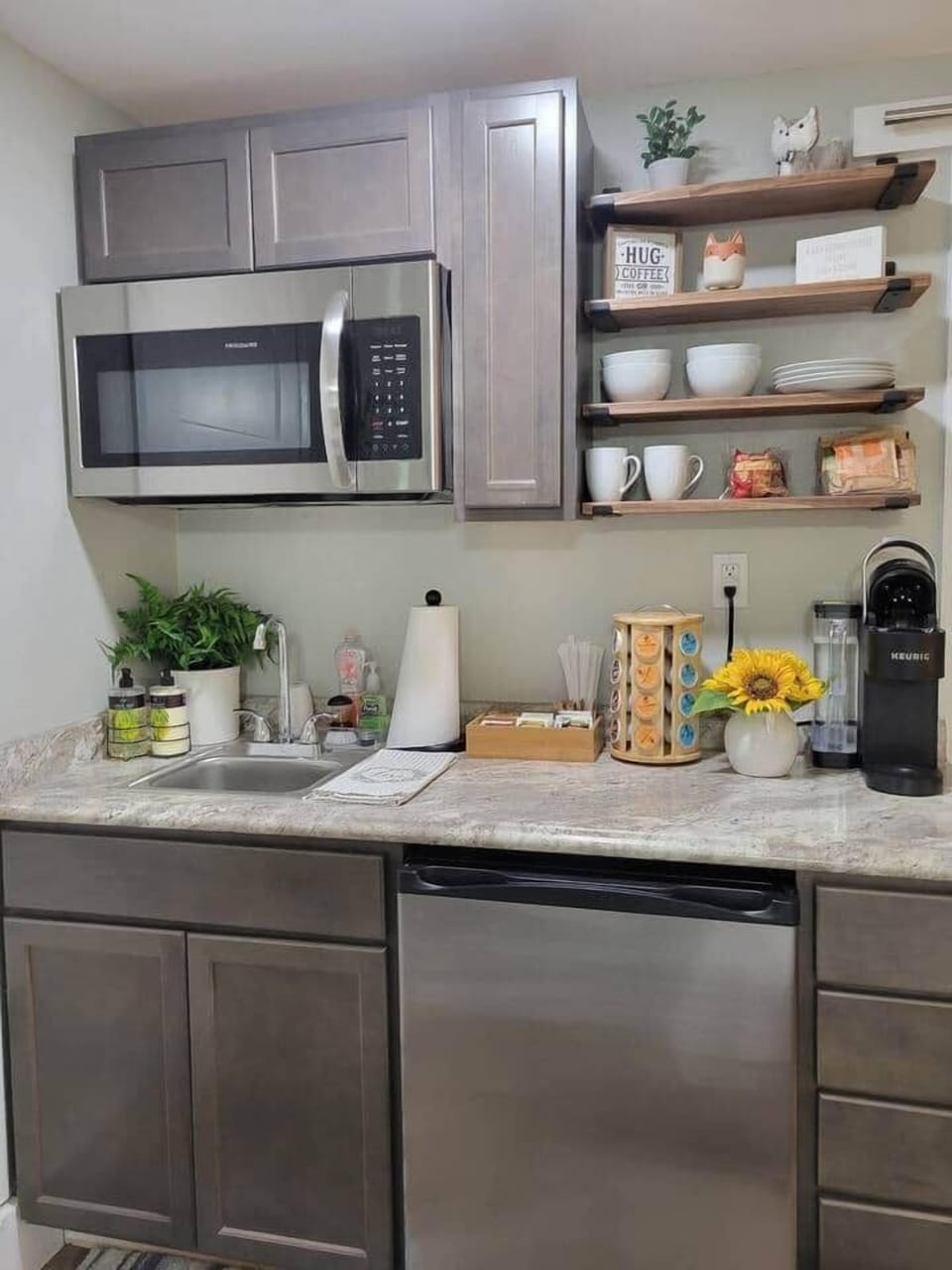 Kitchenette includes, refrigerator, microwave, and sink.