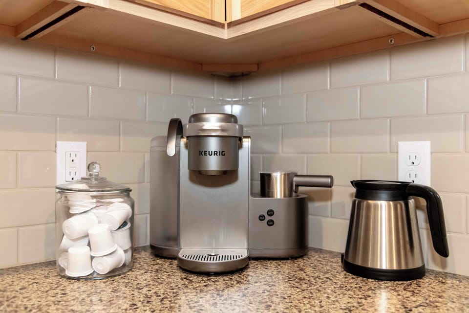 Keurig coffee maker with stocked coffee essentials.
