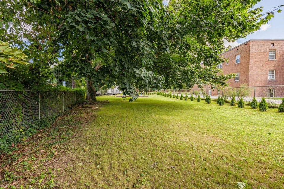 Spacious backyard with a fun playset, perfect for kids to play and adults to relax. Plenty of open space for outdoor activities, or enjoying sunny days in a private setting.