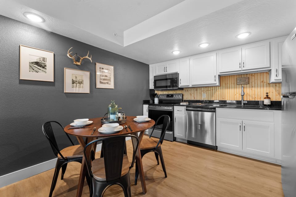Gather around the dining table for four near the fully equipped kitchen; rustic art and deer antlers add Ozark charm to your stay.