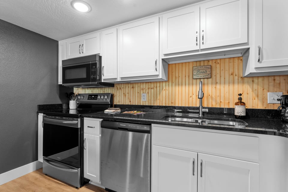 Prepare meals with ease in the modern kitchen, featuring stainless steel appliances, ample counter space, and all the essentials for home-style cooking.