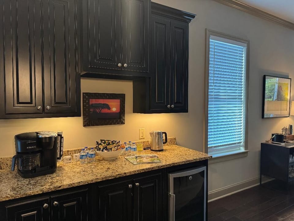 The kitchen includes a beverage station with a wine cooler.