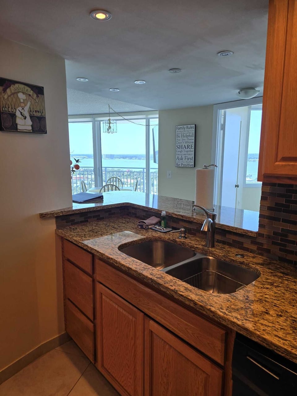View from the kitchen past the breakfast bar to the private balcony.