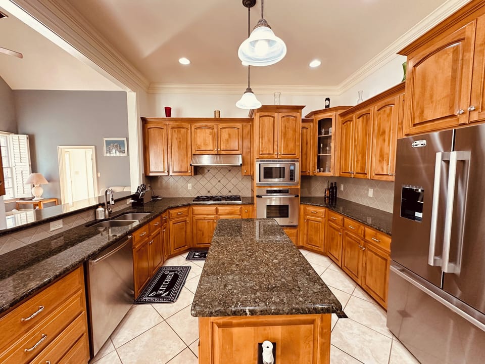 Fully stocked kitchen with premium appliances and granite countertops