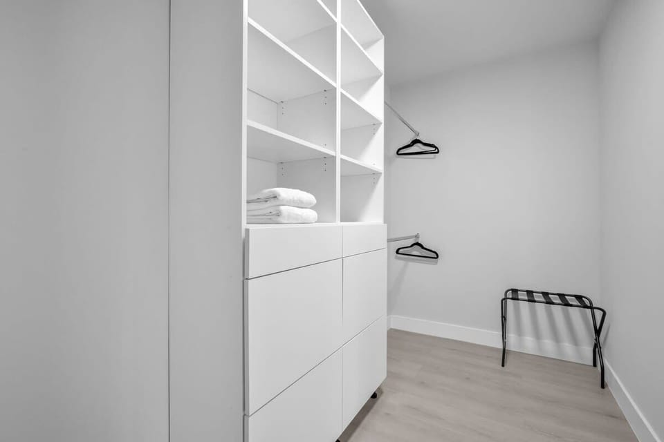Relax in Bedroom 1 featuring a king-sized bed, ample closet space, a dressing table perfect for getting ready or working, plus your own ensuite bathroom.