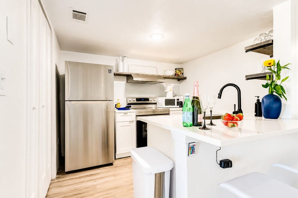 Bright modern kitchen with stainless appliances and stylish breakfast bar