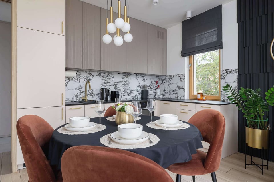 A cozy dining area with a round table and designer lighting is perfect for evenings with wine or board games.