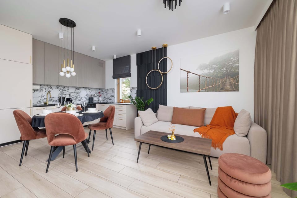 The harmonious blend of dining and living areas makes the space open, cozy, and full of warmth.