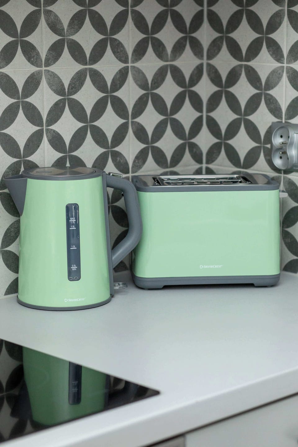 Another kitchen view focusing on the stove, sink, and backsplash tiles. Compact yet functional for daily use.