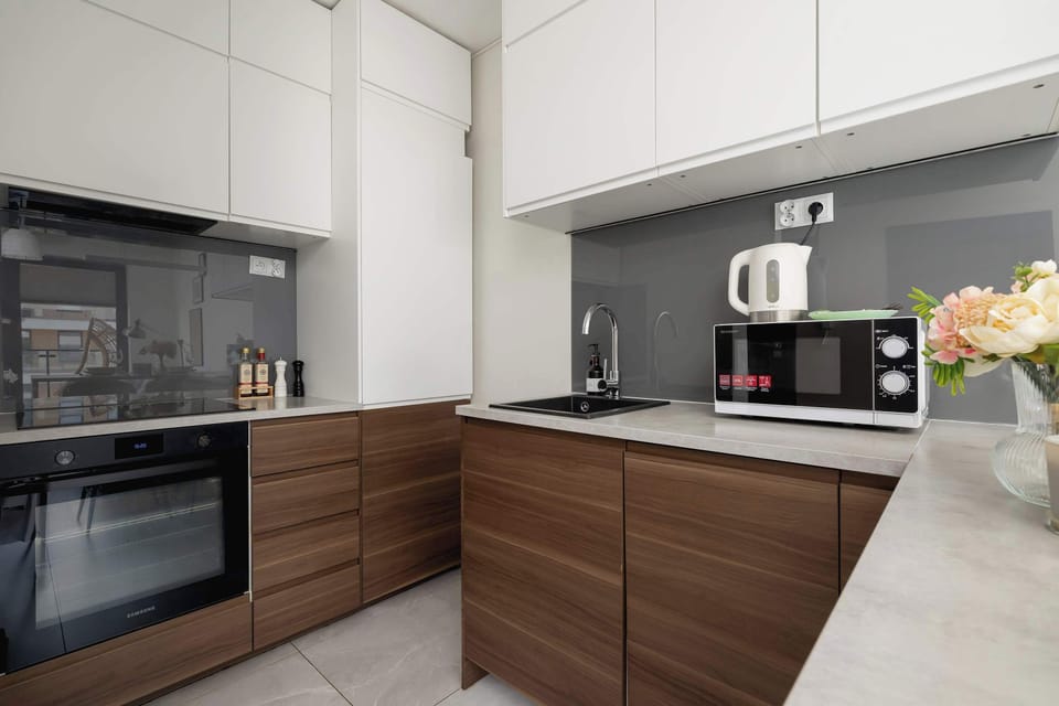 The sleek design of the kitchenette blending seamlessly with the living area.