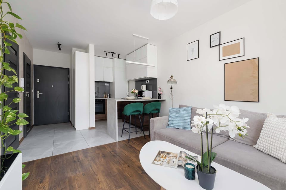 The cozy living room featuring a comfy sofa perfect for relaxing after a day of exploring the city.
