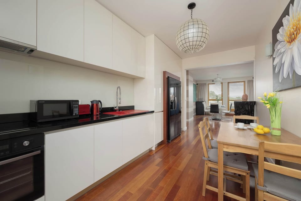 Kitchen is connecting with dining area with natural lighting.