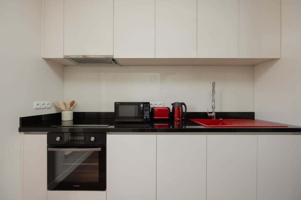 Kitchen with modern appliances and long counter.