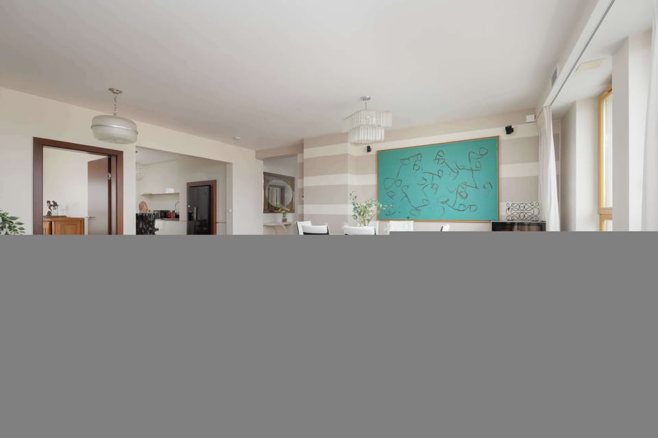 Bright living space with comfortable blue sofa and large windows.
