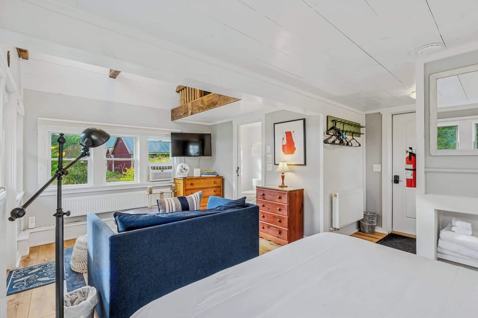 Living area with smart TV, antique dresser, and views of the Vermont hillside