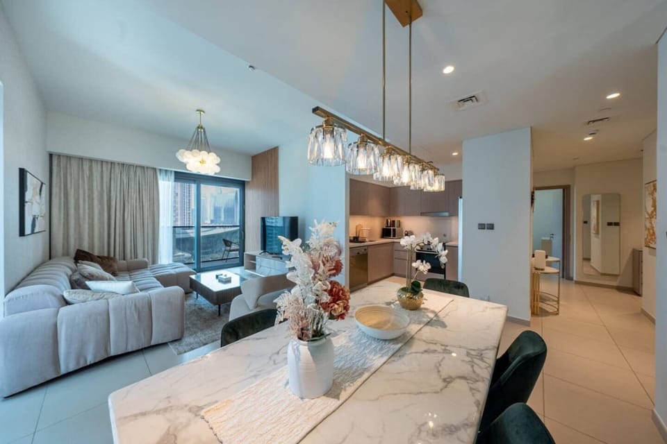 The dining area is adorned with six plush emerald green velvet chairs!
