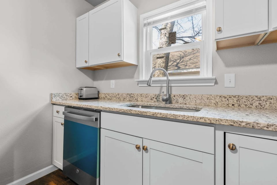 The modern kitchen is elevated with the addition of luxurious marble surfaces.
