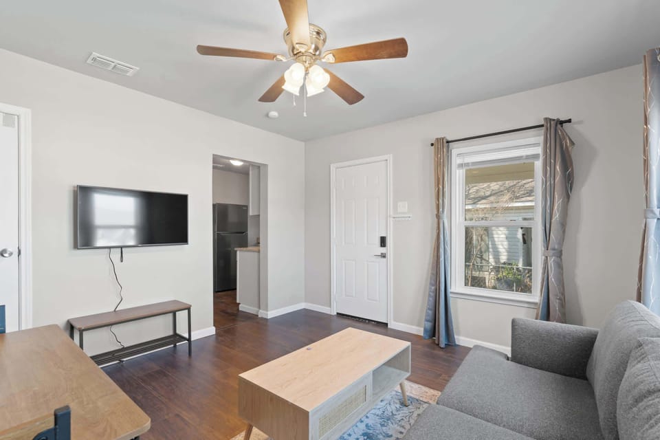 This living room is the ultimate entertainment hub, where the large flat-screen TV takes center stage, framed by comfortable seating and stylish décor.