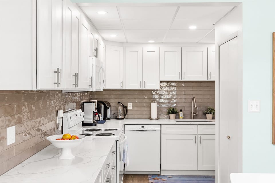 Fully equipped kitchen with modern appliances and space for home-cooked meals.