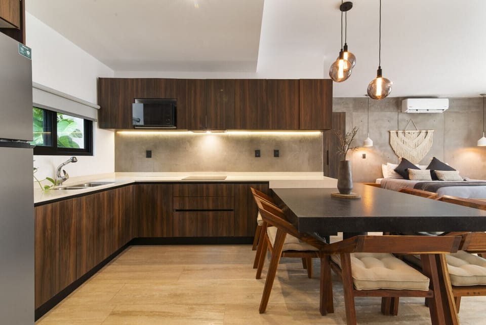 Contemporary kitchen with wood cabinets & cozy lighting.