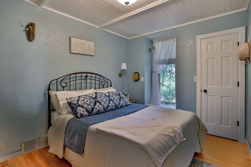 Wake up to peaceful river views from this cozy main level queen bedroom