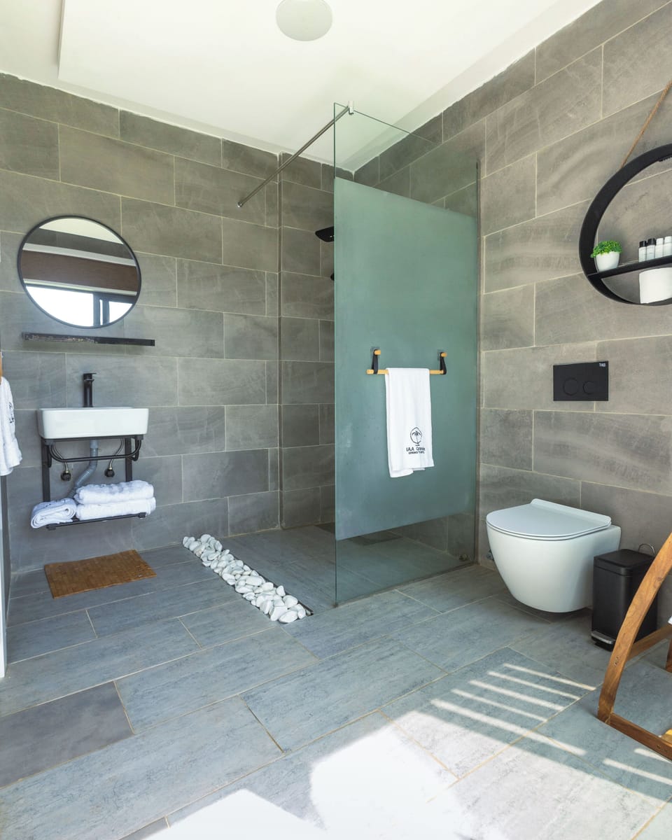 Separate tub and shower, rainfall showerhead, designer toiletries