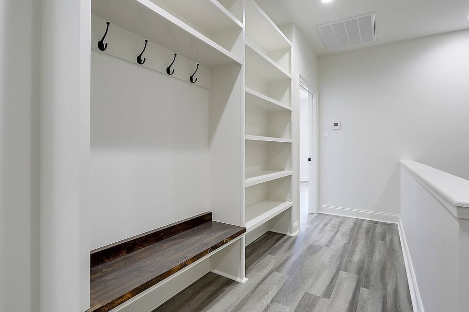 Welcome home: mudroom with built-in storage and coat hooks.