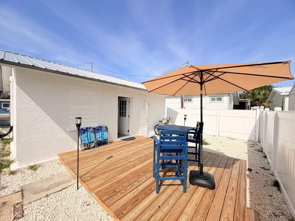 Large patio off the back with dining area, bikes for riding through the neighborhood, beach chairs and a charcoal grill.