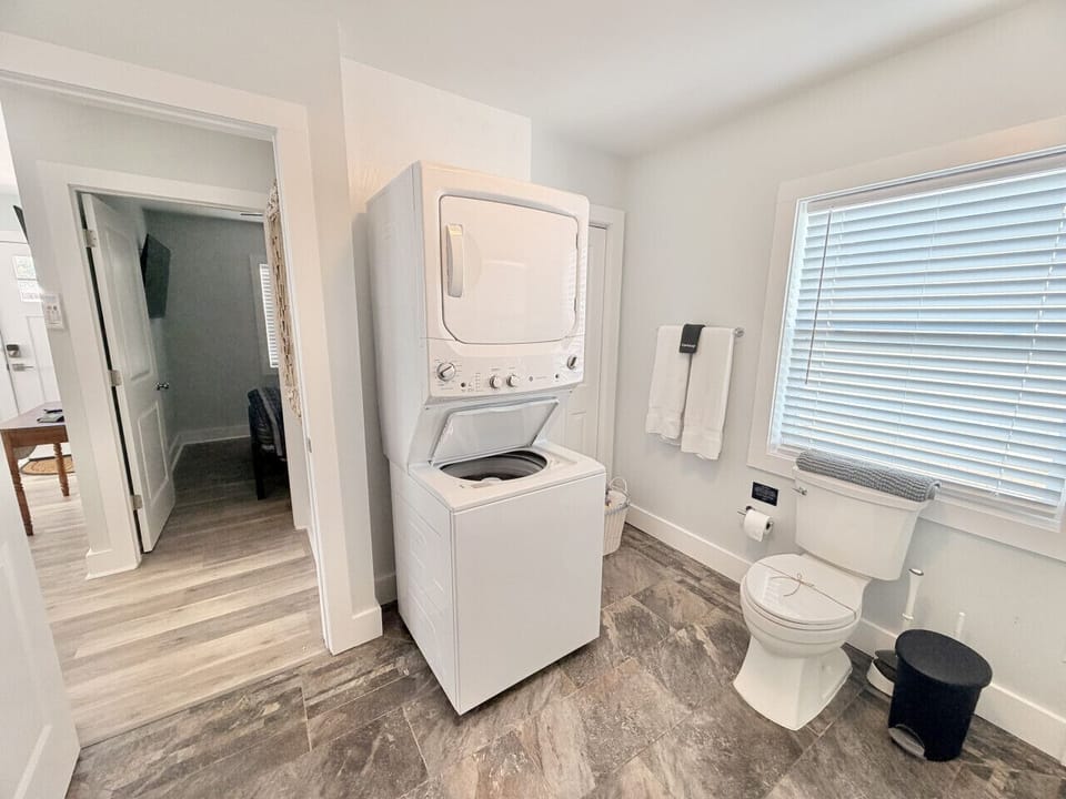 Large bathroom with stall shower, washer/dryer and closet.