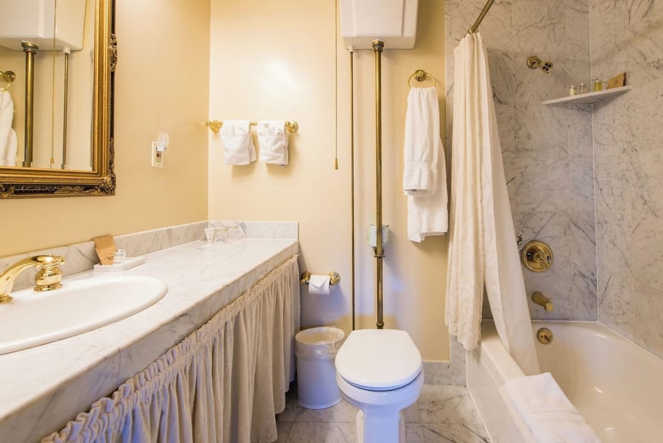 Refresh in a classic marble bath with plush towels.
