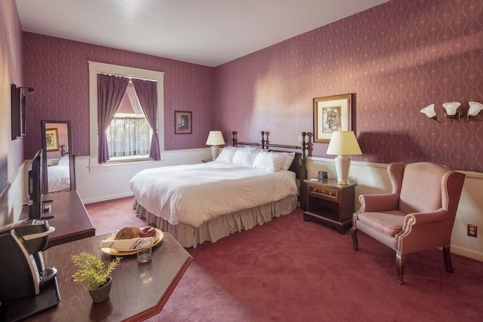 Relax in a classic room with plush bedding and warm tones.
