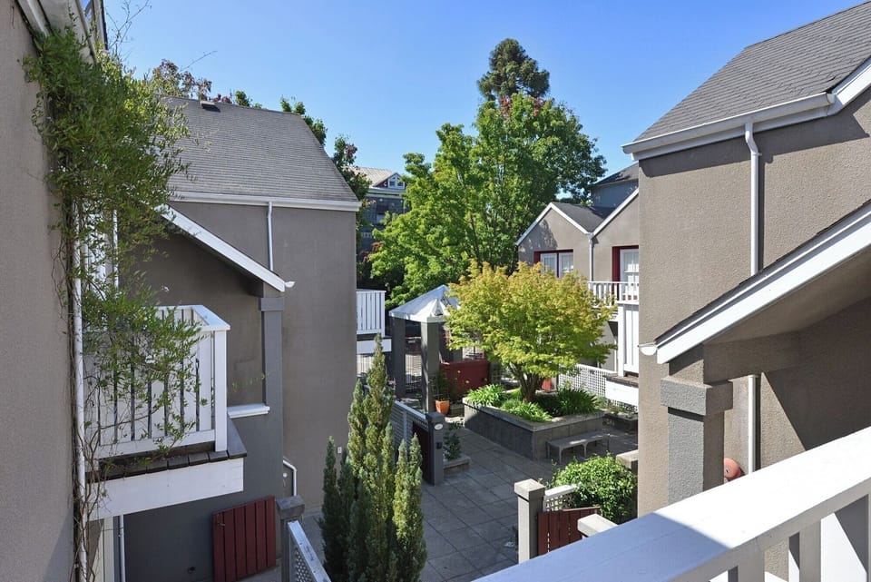 Stroll through a lush courtyard oasis under blue skies.