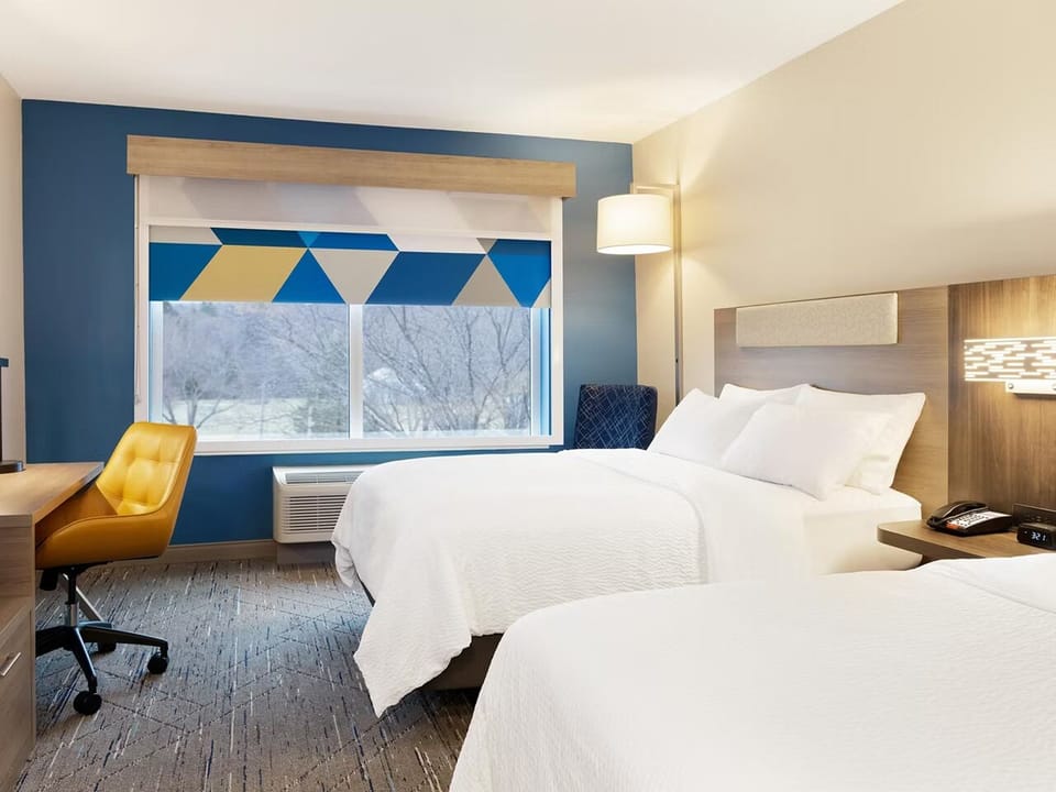 Unwind in crisp beds with calming light and modern style.