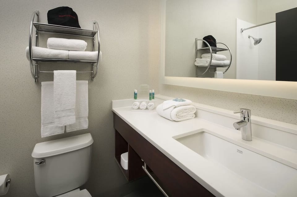 Refresh comfortably with bright vanity space and fluffy towels.