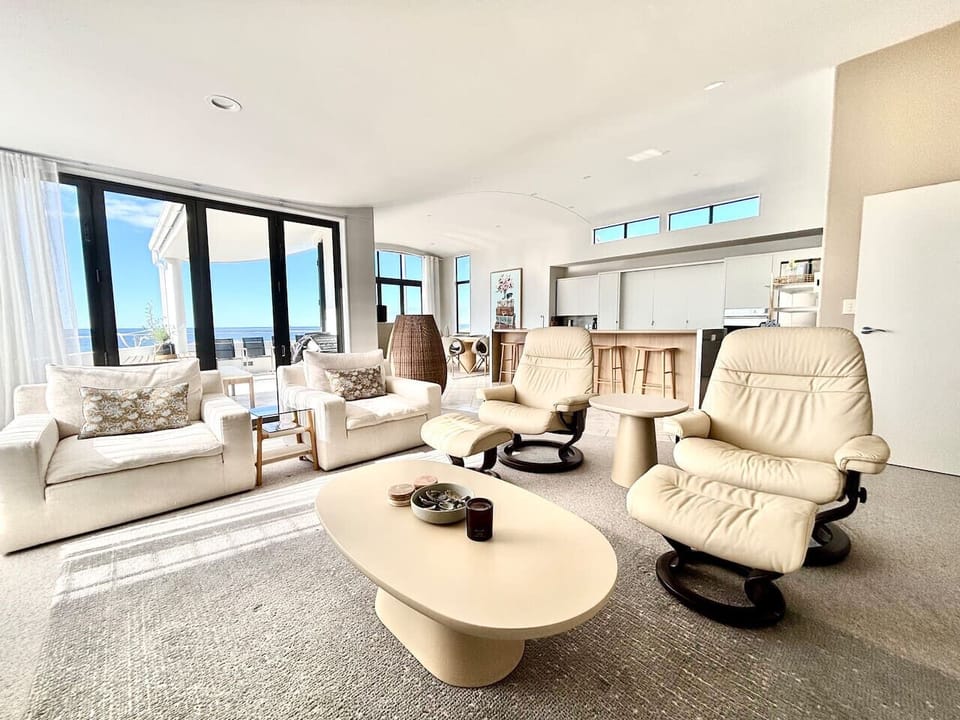 Open Plan Living/Dining out onto upstairs balcony with outdoor dining table and chairs