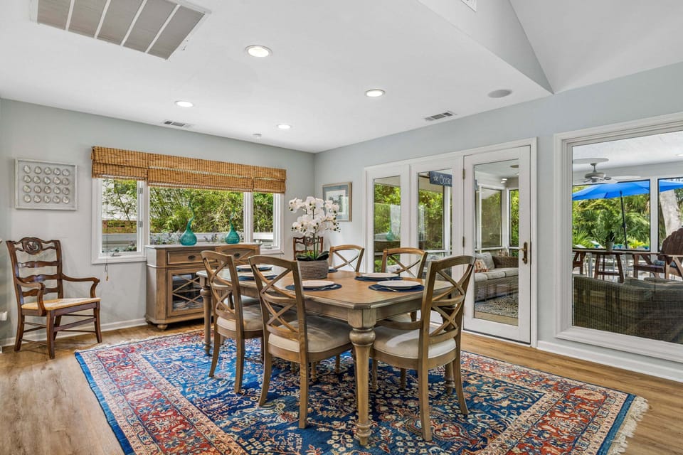 The open layout seamlessly overlooks the dining area with seating for six, offering multiple seating arrangements perfect for shared meals and gatherings.
