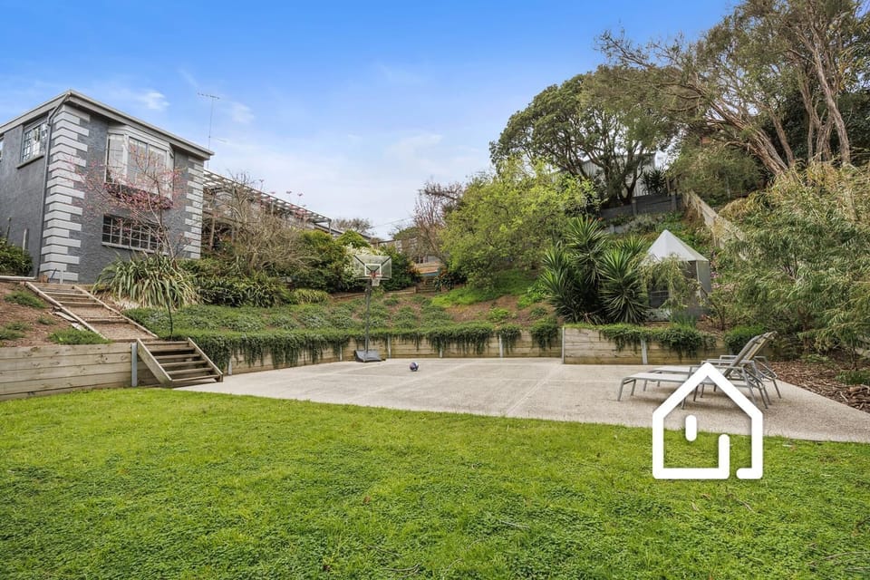 Large lower patio with sun lounges and a basketball ring (BYO basketball)
